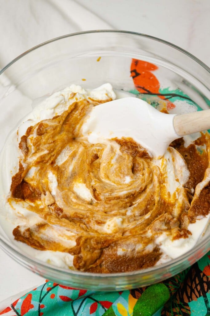 Ice cream and pumpkin mixture in a bowl for pumpkin pie recipe.