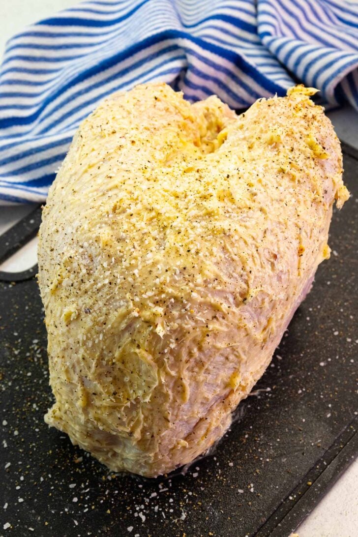 Turkey breast slather with butter flavored with garlic and onion powder, dried thyme, salt and pepper.