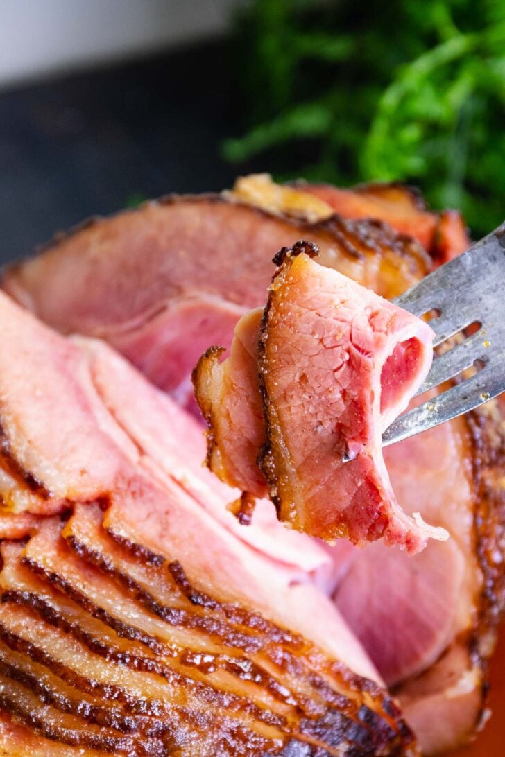 Sliced Copycat Honey Baked Ham served for Thanksgiving and Christmas is a family favorite that's easy to make and mouthwatering delicious.