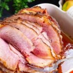 Honey Baked Ham cooked in a sweet glaze is a copycat recipe that's easy to make and over the top delicious.