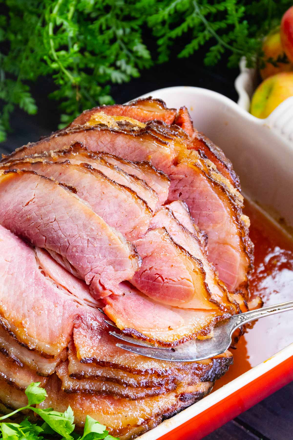 Honey Baked Ham cooked in a sweet glaze is a copycat recipe that's easy to make and over the top delicious.
