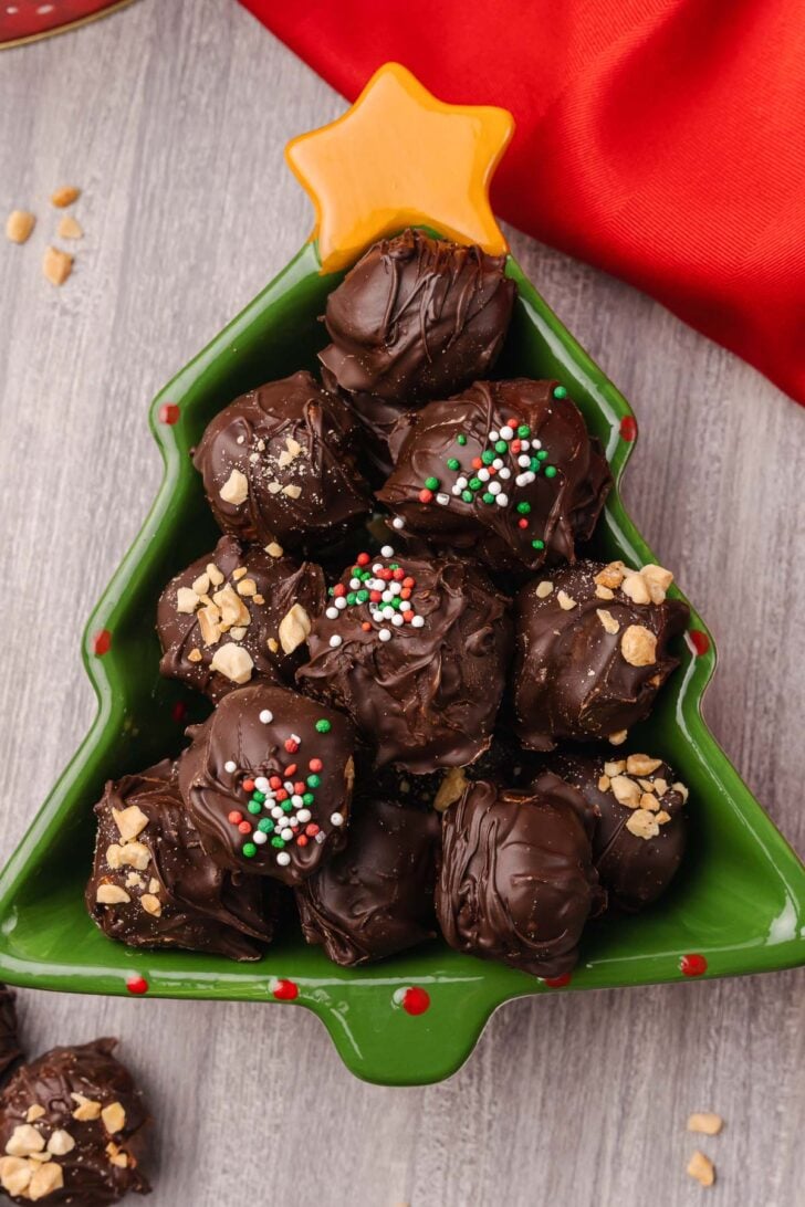 Peanut Butter Balls topped with a drizzle of chocolate and crushed peanuts make a wonderful sweet treat for the holidays and are perfect for gift giving.