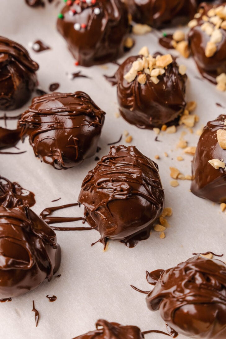 Peanut Butter Balls topped with a drizzle of chocolate and crushed peanuts make a wonderful sweet treat for the holidays and are perfect for gift giving.