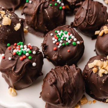 Peanut Butter Balls topped with a drizzle of chocolate and crushed peanuts make a wonderful sweet treat for the holidays and are perfect for gift giving.