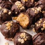 Peanut Butter Balls topped with a drizzle of chocolate and crushed peanuts make a wonderful sweet treat for the holidays and are perfect for gift giving.