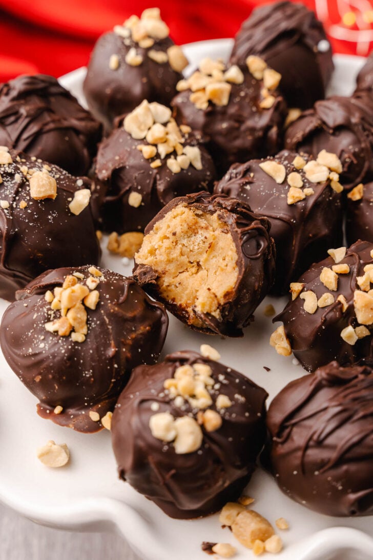 Peanut Butter Balls topped with a drizzle of chocolate and crushed peanuts make a wonderful sweet treat for the holidays and are perfect for gift giving.