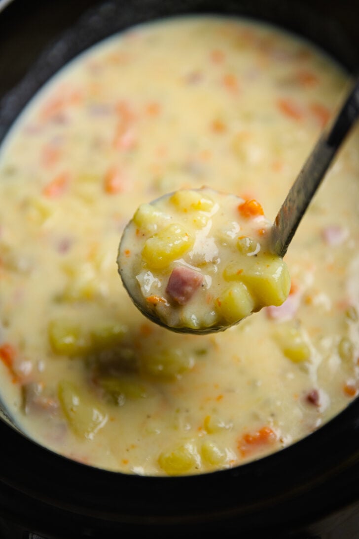 Crock Pot Ham And Potato Soup is full of vegetables and the perfect comfort food served with warm bread on a chilly night.