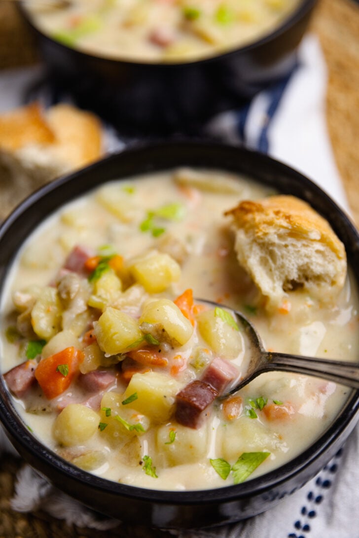Crock Pot Ham And Potato Soup is full of vegetables and the perfect comfort food served with warm bread on a chilly night.