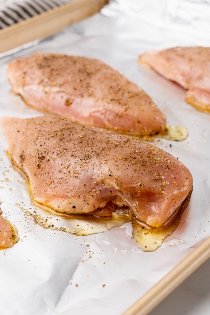 Tender, and juicy oven baked chicken with a rich BBQ sauce with all the flavors you love from summer grilling is easy to make and the perfect weeknight meal.