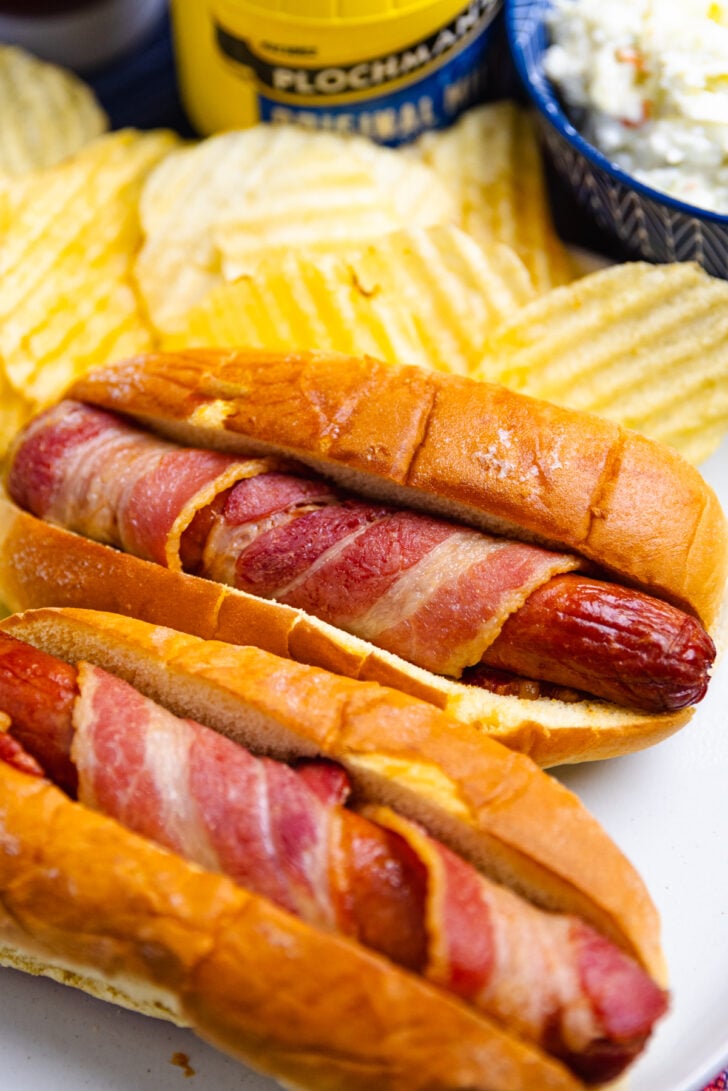 hot dogs cooked in the air fryer then wrapped in bacon placed in a soft buttered bun.