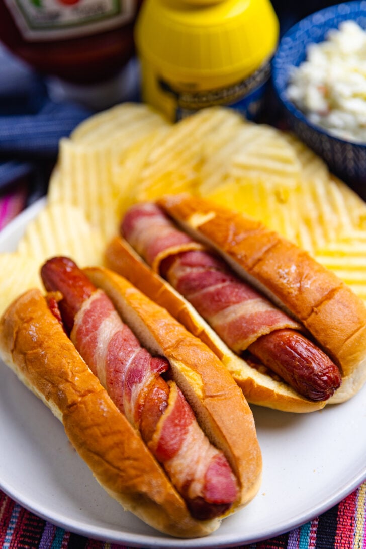 hot dogs cooked in the air fryer then wrapped in bacon placed in a soft buttered bun.