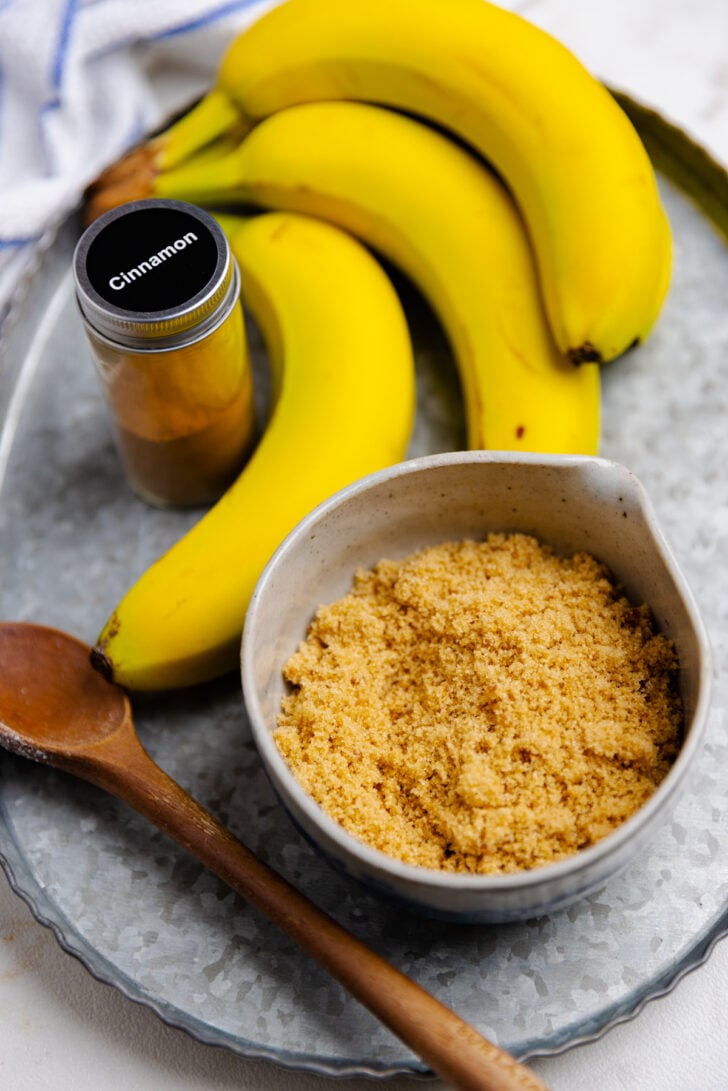 Bananas, brown sugar, cinnamon on a tray ready to make Air Fryer Bananas.