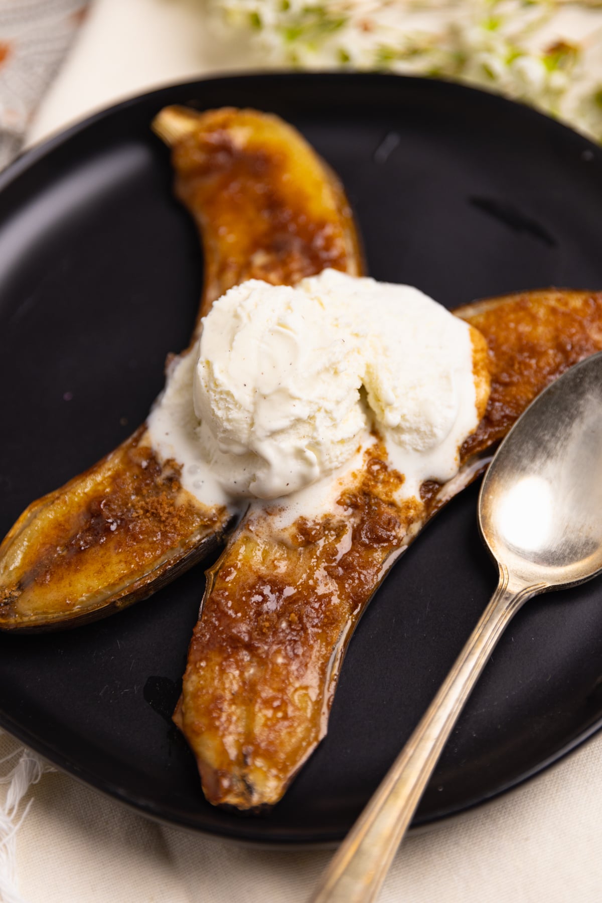 Air Fryer Bananas are caramelized with brown sugar and served with vanilla ice cream for a delicious dessert or treat that's easy to make in less than 10 minutes.
