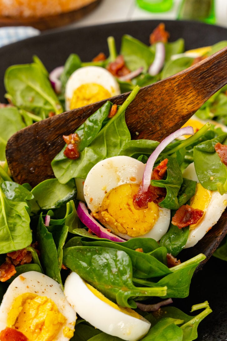 Fresh spinach, sliced red onion, crispy cooked bacon and boiled egg tossed in a warm bacon dressing tossed with wooden thongs.