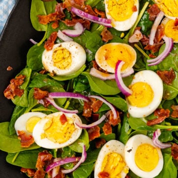 Fresh spinach, sliced red onion, crispy cooked bacon and boiled egg tossed in a warm bacon dressing tossed with wooden thongs.