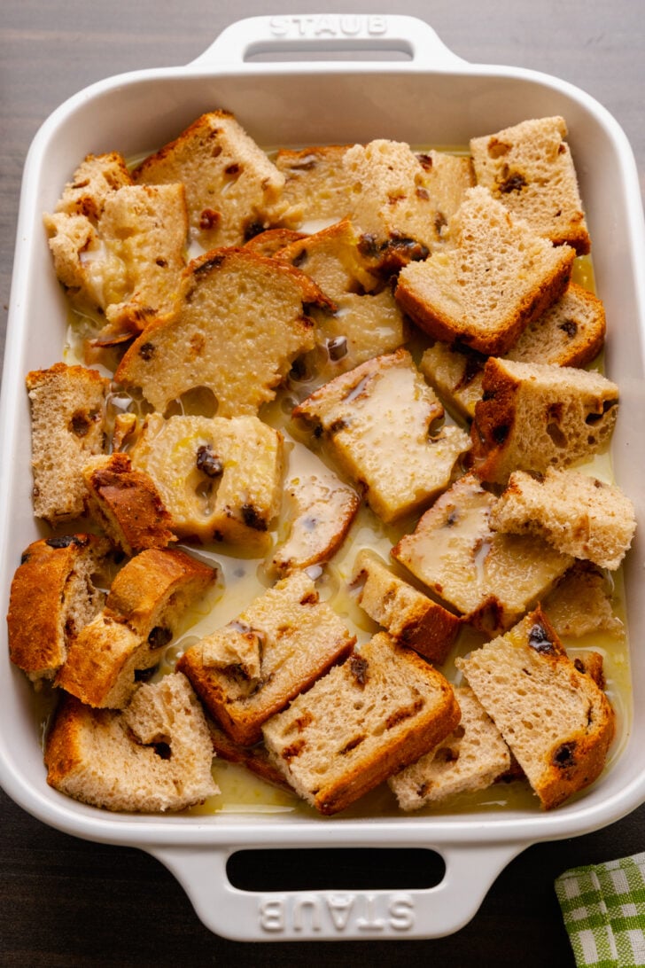 Warm, sweet bread pudding is easy to make with slices of cinnamon raisin bread, eggs, spices and butter. The inside is rich and soft with crispy edges on the outside.