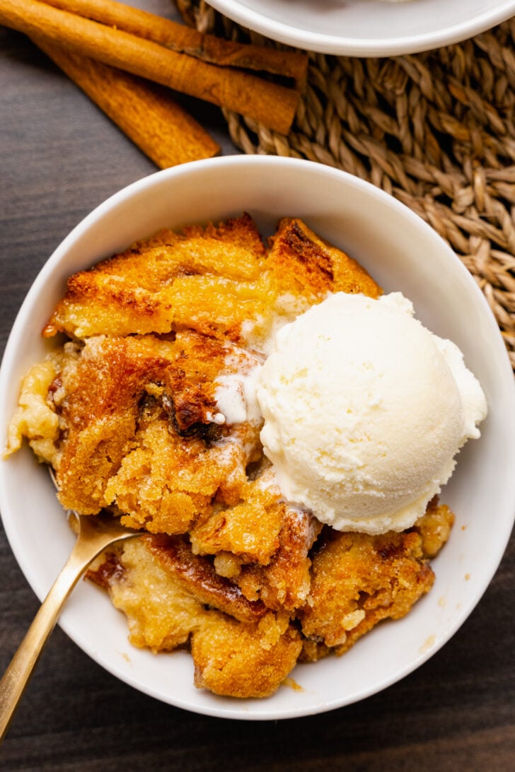 Warm, sweet bread pudding is easy to make with slices of cinnamon raisin bread, eggs, spices and butter. It's baked and served with vanilla ice cream for a delicious dessert or for breakfast or brunch.