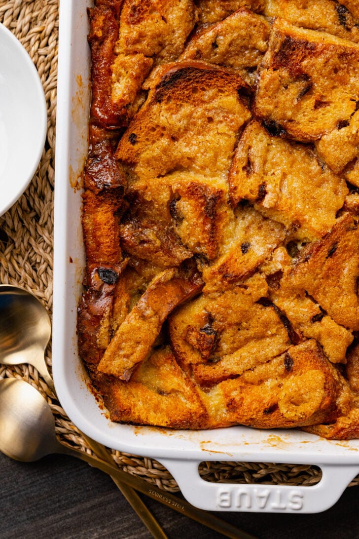 Warm, sweet bread pudding is easy to make with slices of cinnamon raisin bread, eggs, spices and butter. The inside is rich and soft with crispy edges on the outside.