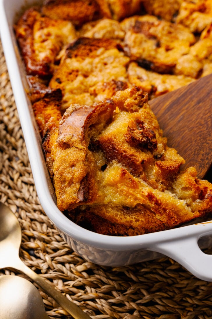 Warm, sweet bread pudding is easy to make with slices of cinnamon raisin bread, eggs, spices and butter. The inside is rich and soft with crispy edges on the outside.