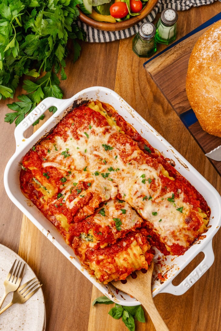 Spinach and cheese roll ups topped with tomato sauce and baked with a cheese topping is a twist on traditional lasagna that is so easy to make for a family meal.