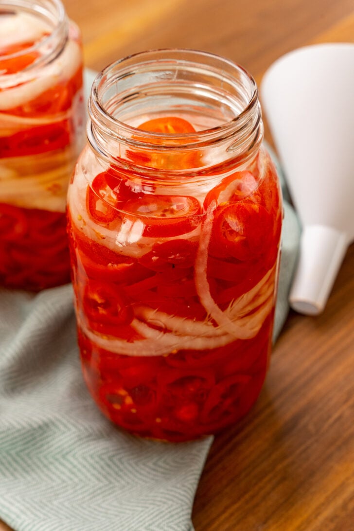Quick Pickled Sweet Red Pepper And Onions are easy to make without in a salty brine the trouble of traditional canning and are great on burgers, hot dogs, sandwiches and tacos!