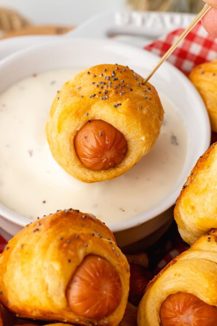 Crescent roll pigs in a blanket dipped into ranch dressing are easy to make and the perfect party finger food.