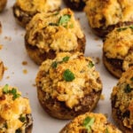 Baked mushrooms stuffed with breadcrumbs, cream cheese, parmesan cheese, garlic and herbs then sprinkled with shopped fresh parsley are the perfect finger food for any party.