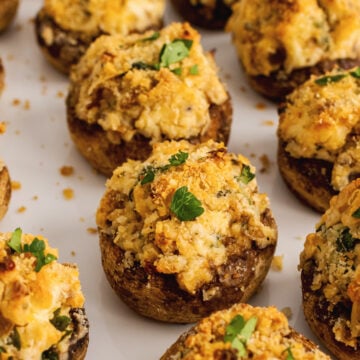 Baked mushrooms stuffed with breadcrumbs, cream cheese, parmesan cheese, garlic and herbs then sprinkled with shopped fresh parsley are the perfect finger food for any party.
