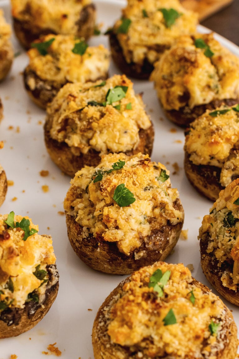 Baked mushrooms stuffed with breadcrumbs, cream cheese, parmesan cheese, garlic and herbs then sprinkled with shopped fresh parsley are the perfect finger food for any party.