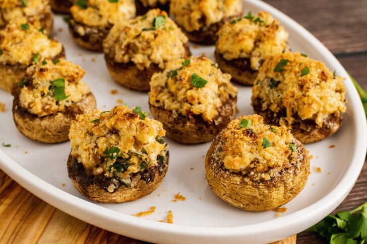 Baked mushrooms stuffed with breadcrumbs, cream cheese, parmesan cheese, garlic and herbs are the perfect finger food for any party.