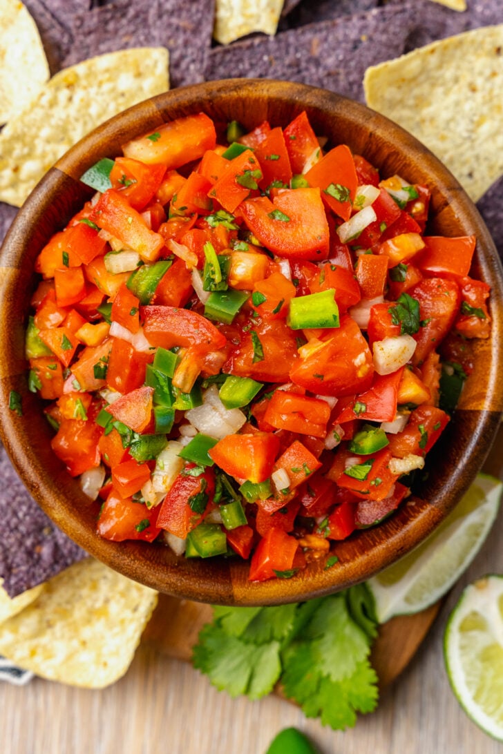 Homemade fresh pico de gallo with tomatoes, onions, jalapeno, cilantro and lime served with chips is a great appetizer and also makes a terrific topping for chicken, beef or fish!