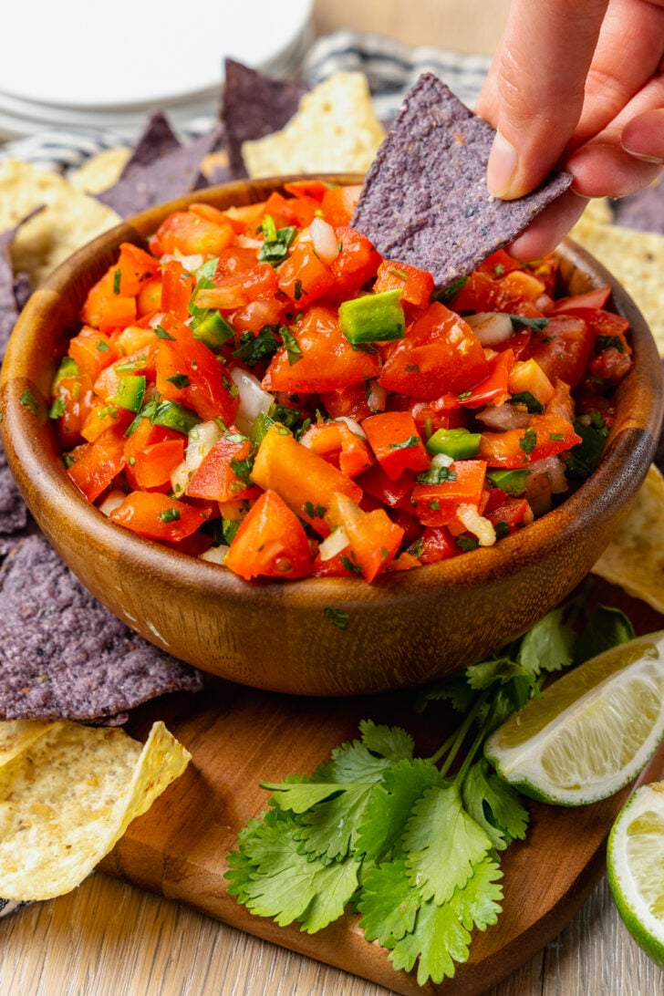 Homemade fresh pico de gallo with tomatoes, onions, jalapeno, cilantro and lime served with chips is a great appetizer and also makes a terrific topping for chicken, beef or fish!