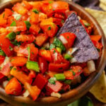 Homemade fresh pico de gallo with tomatoes, onions, jalapeno, cilantro and lime served with chips is a great appetizer and also makes a terrific topping for chicken, beef or fish!
