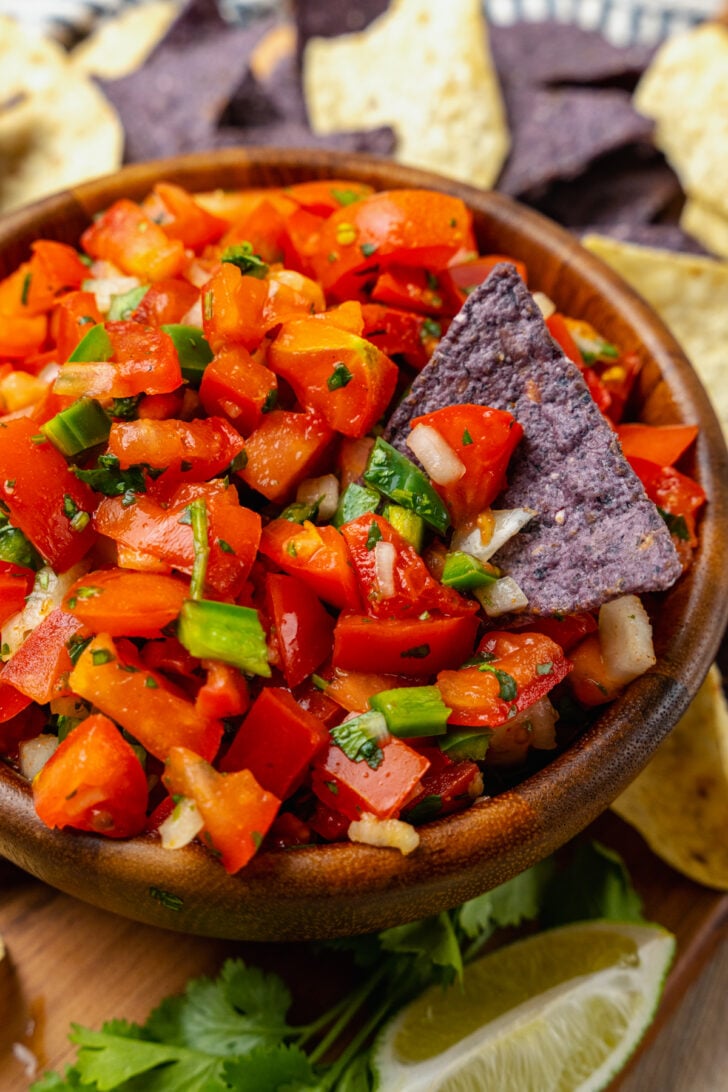 Homemade fresh pico de gallo with tomatoes, onions, jalapeno, cilantro and lime served with chips is a great appetizer and also makes a terrific topping for chicken, beef or fish!