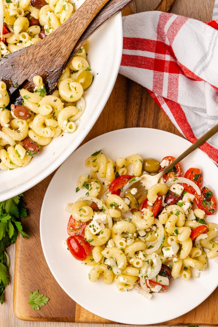 Greek pasta salad made with a store-bought shortcut is easy to make with pasta, feta cheese, tomatoes and onions in a light olive oil dressing. It's the perfect side dish or main to serve any time of the year!