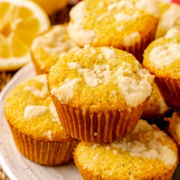 Lemon Poppy Seed Muffins with a sweet topping baked in cupcake papers are the perfect easy to make treat for breakfast, brunch or a grab and go treat.