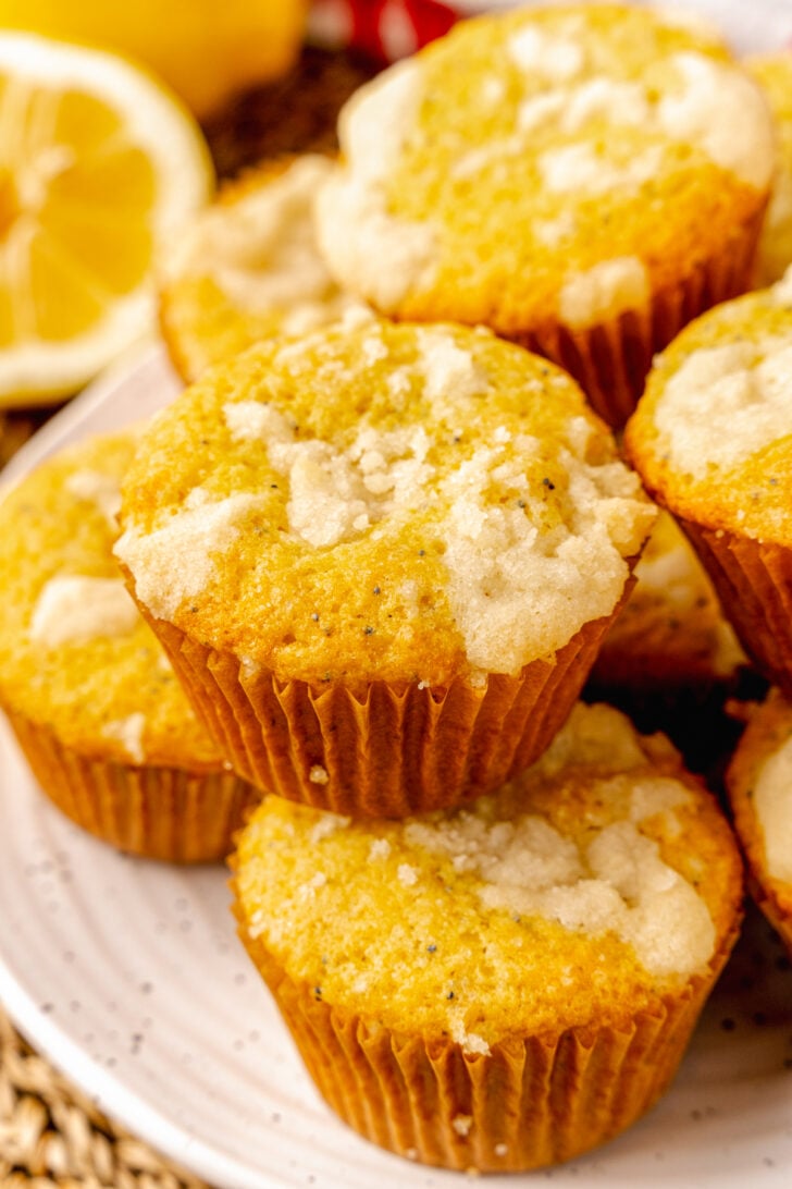 Lemon Poppy Seed Muffins with a sweet topping baked in cupcake papers are the perfect easy to make treat for breakfast, brunch or a grab and go treat.