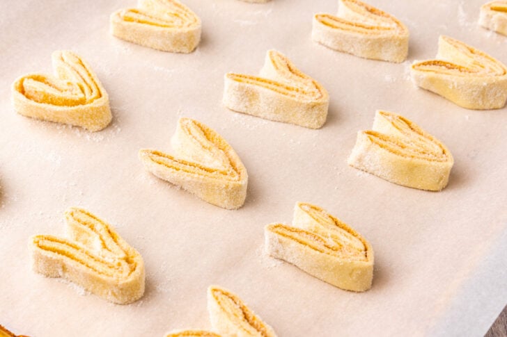 Puffed pastry with sugar and cinnamon but into slices to make Palmiers.