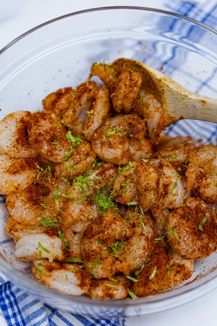 Large shrimp tossed in chili, garlic powder, onion powder, salt and lime zest for Sheet Pan Chili Lime Shrimp Fajitas.