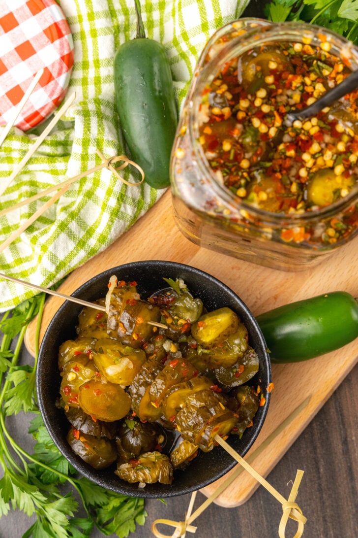 Sweet Heat Pickles marinated in red pepper, sugar, garlic, parsley and jalapeños are crazy delicious and so easy to make. They are great as a snack, with burgers, chicken, and perfect for a charcuterie board!