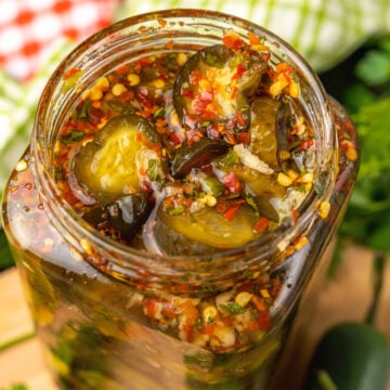 Jar or Sweet Heat Pickles marinated in red pepper, sugar, garlic, parsley and jalapeños are crazy delicious and so easy to make. They are great as a snack, with burgers, chicken, and perfect for a charcuterie board!