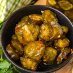 Black bowl with Sweet Heat Pickles marinated in red pepper, sugar, garlic, parsley and jalapeños are crazy delicious and so easy to make. They are great as a snack, with burgers, chicken, and perfect for a charcuterie board!