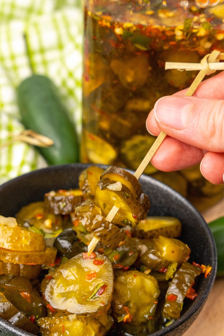Wooden skewer with Sweet Heat Pickles marinated in red pepper, sugar, garlic, parsley and jalapeños are crazy delicious and so easy to make. They are great as a snack, with burgers, chicken, and perfect for a charcuterie board!
