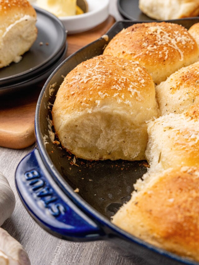 Dinner rolls made with garlic, butter and Parmesan cheese made from store bought rolls made in a cast iron skillet.
