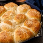 Dinner rolls made with garlic, butter and Parmesan cheese made from store bought rolls made in a cast iron skillet.