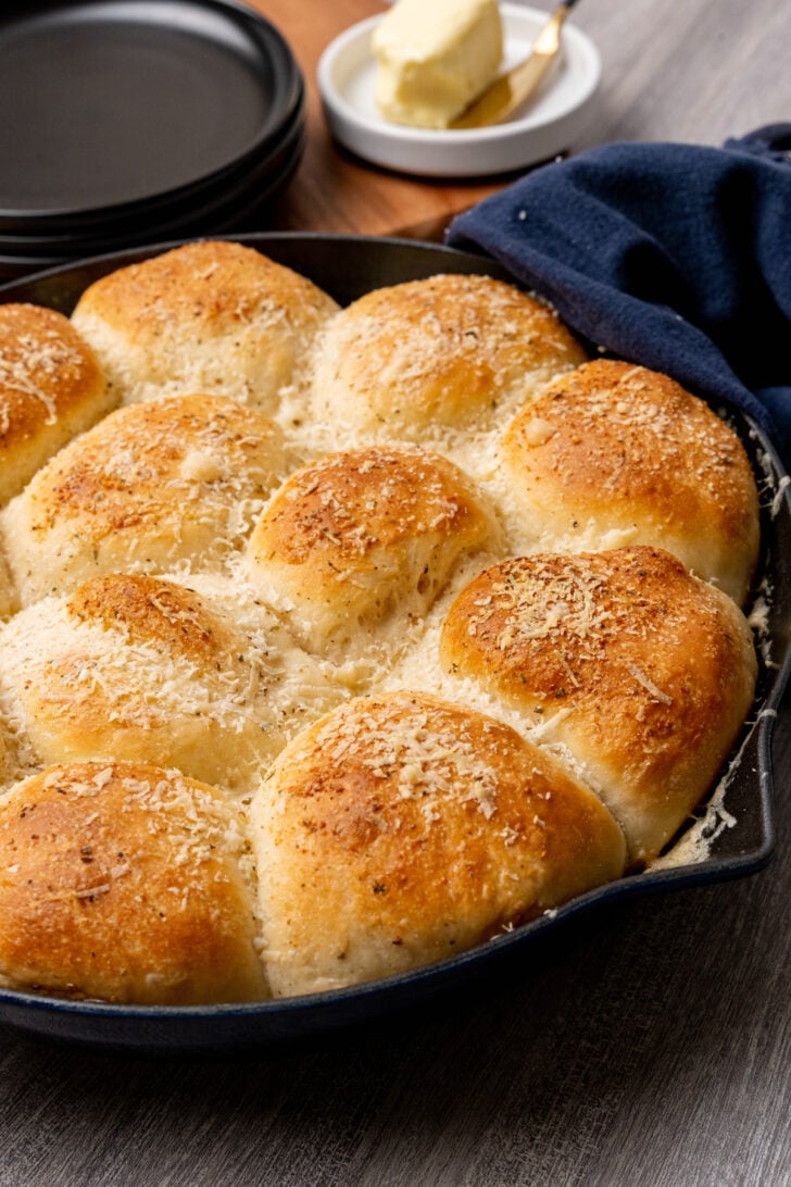 Dinner rolls made with garlic, butter and Parmesan cheese made from store bought rolls made in a cast iron skillet.