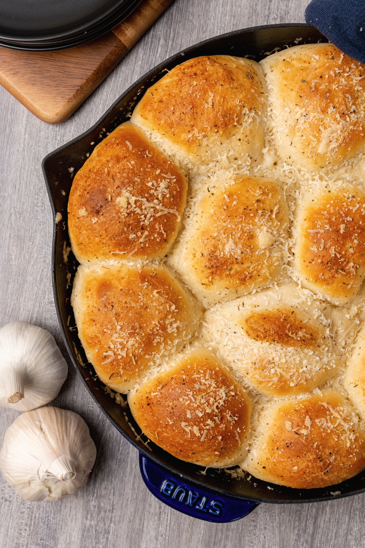 Dinner rolls made with garlic, butter and Parmesan cheese made from store bought rolls made in a cast iron skillet.