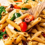 Whole wheat penne pasta tossed with fresh tomatoes, spinach, black olives in lemon juice and olive oil the topped with shaved Parmesan Cheese.