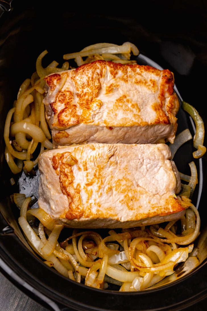 Crock Pot Pineapple Pork Roast cooked low and slow with caramelized onions in a rich garlic, red pepper sauce is easy to make for dinner.