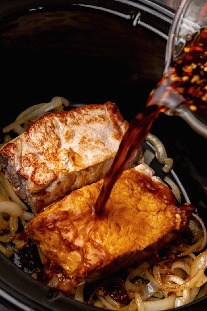 Crock Pot Pineapple Pork Roast cooked low and slow in a rich garlic, red pepper sauce is easy to make for dinner.